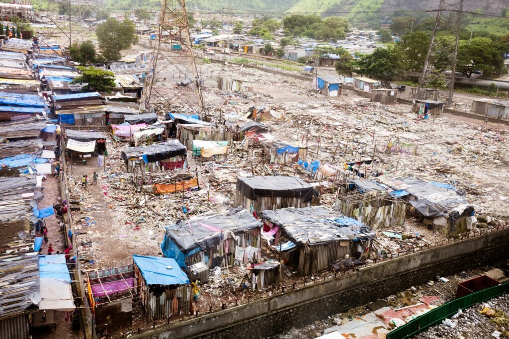 A vast informal settlement with densely packed makeshift shelters.