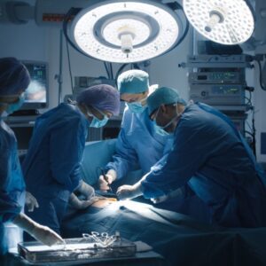Surgical team performing operation under bright lights
