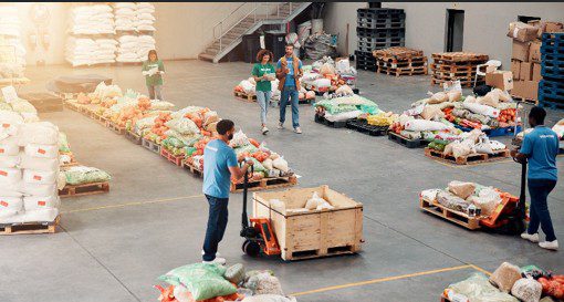 Volunteers sorting food donations in warehouse