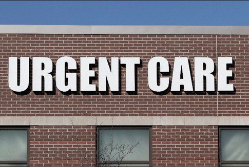 Urgent care sign on brick building