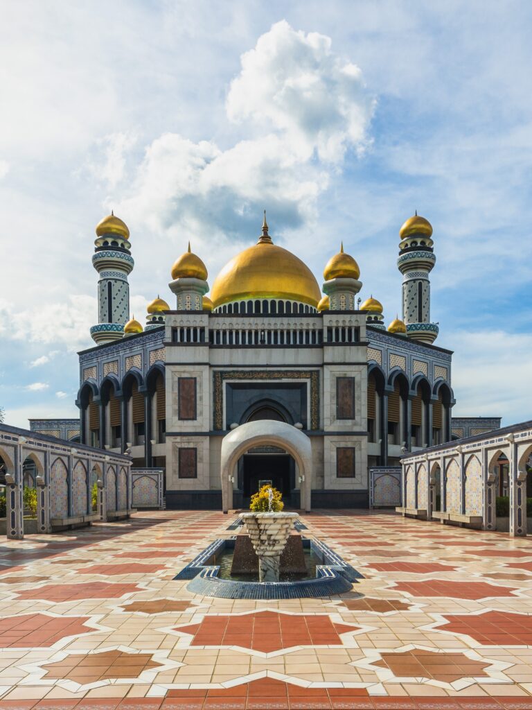 Grand mosque with golden domes and fountain