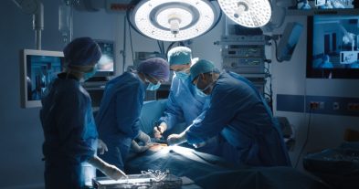Surgical team performing operation under bright lights